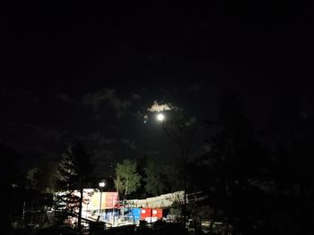 Illuminated city against sky at night