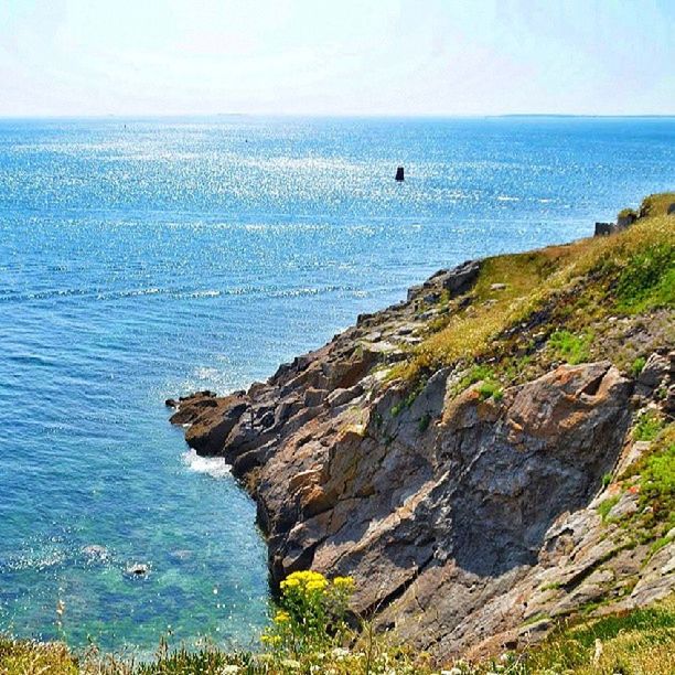 sea, horizon over water, water, scenics, tranquil scene, tranquility, beauty in nature, cliff, rock formation, blue, nature, rock - object, rock, clear sky, idyllic, sky, seascape, day, coastline, mountain