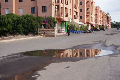 Road by buildings in city