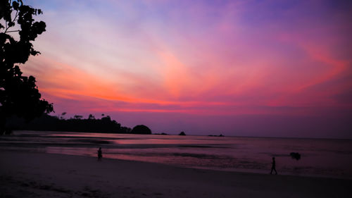 Scenic view of beach against sky during sunset