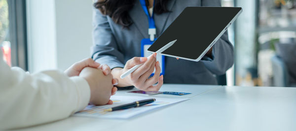 Midsection of businesswoman working at office