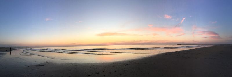 Scenic view of beach against sky during sunset