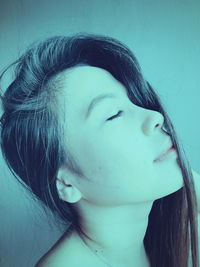 Close-up portrait of young woman looking away