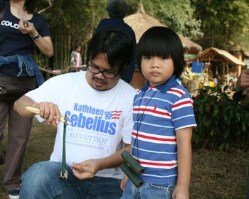 Portrait of boy with father on field