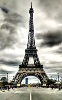 Low angle view of eiffel tower against cloudy sky