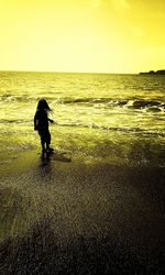 Silhouette of woman standing on field