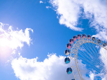 Low angle view of ferris wheel against sky