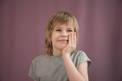 Portrait of smiling girl against wall