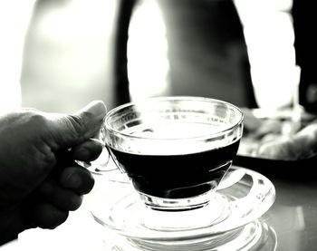 Close-up of hand holding coffee cup