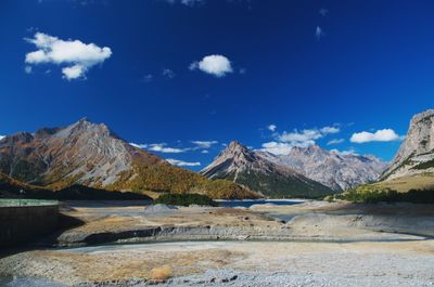 Scenic view of mountains against blue sky