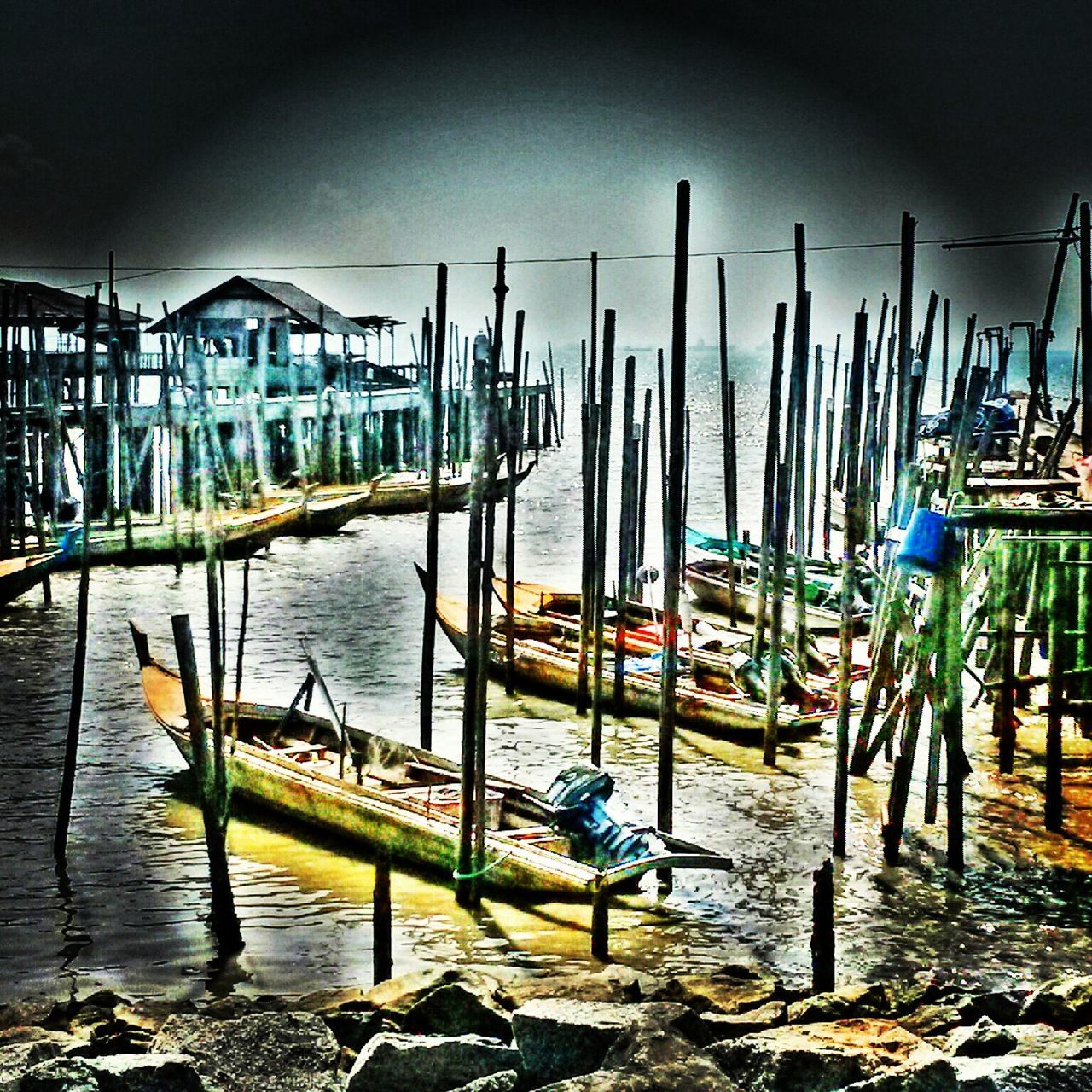 moored, water, nautical vessel, harbor, transportation, boat, mode of transport, sky, large group of objects, in a row, built structure, sea, reflection, outdoors, abundance, wooden post, architecture, no people, day, building exterior