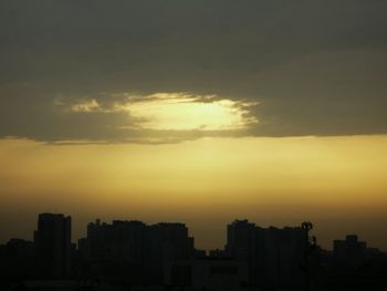 Buildings in city at sunset