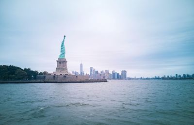 Lady liberty and lower manhattan.