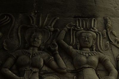 Sculpture of statues on wall of building