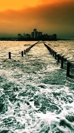 Pier on sea at sunset
