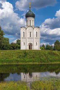 Scenic view of lake by building against sky