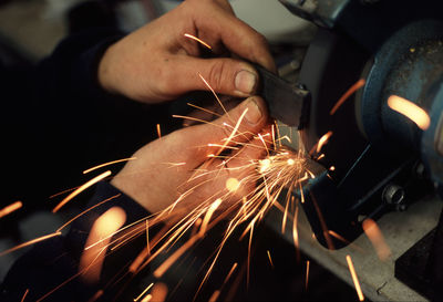 Sparks emitting while worker grinding iron