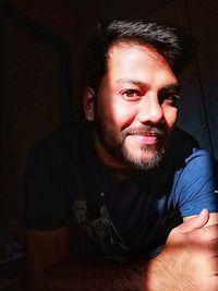 Portrait of young man sitting at home