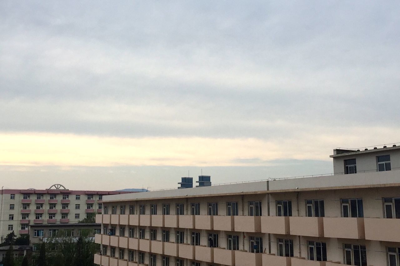 architecture, building exterior, built structure, sky, residential building, residential structure, cloud - sky, low angle view, building, window, city, cloudy, house, cloud, outdoors, day, residential district, no people, balcony, overcast