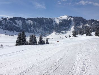 Snow covered landscape against sky