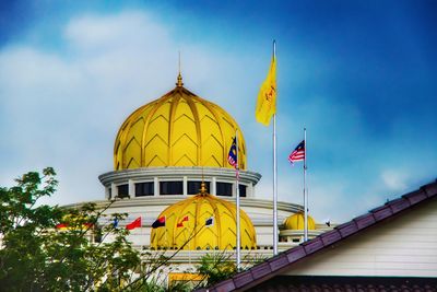 Low angle view of yellow traditional building against sky