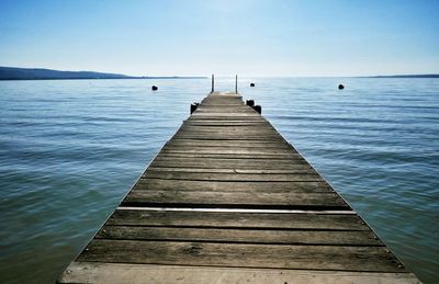 Pier over sea against clear sky