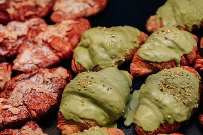 Delicious sweet freshly baked croissants with almond nuts and pistachio cream