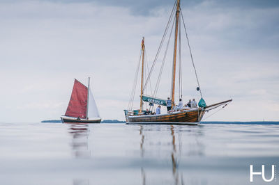 Sailboat sailing in sea against sky