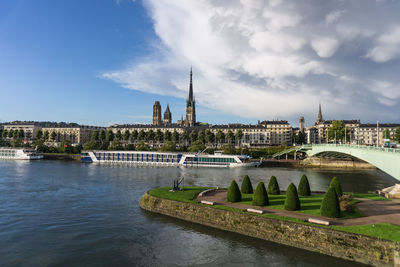 Bridge over river against buildings in city