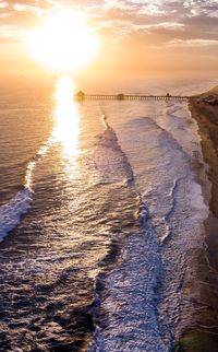 Scenic view of beach against sky during sunset