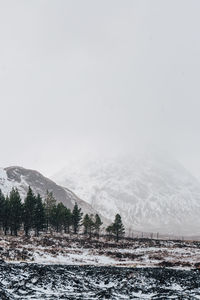 Scenic view of mountains against clear sky during winter