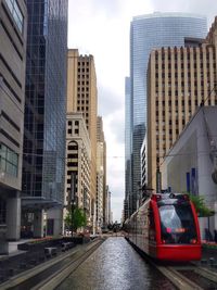 View of city street and buildings against sky