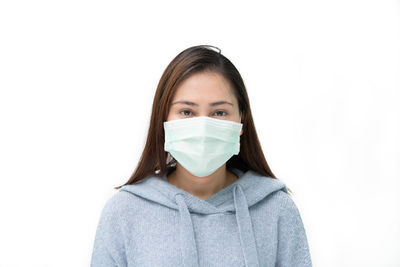 Portrait of a young woman over white background