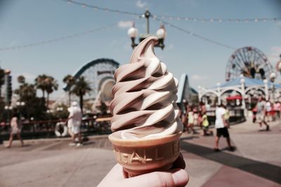 Close-up of ice cream cone against sky