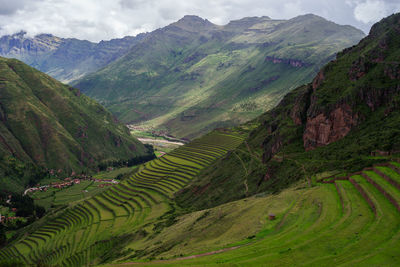 Scenic view of rocky mountains against cloudy sky