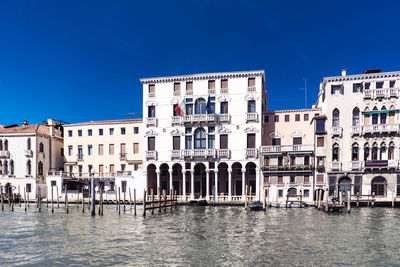 Buildings against clear blue sky