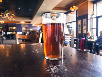 Close-up of beer glass on table