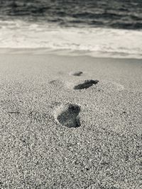 High angle view of footprints on beach