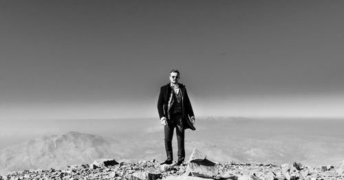 Full length of man standing on land against sky