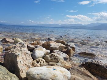 Rocks on beach against sky