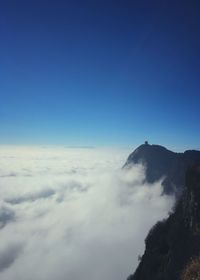 Scenic view of mountains against blue sky