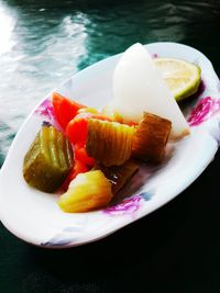 Close-up of fruits in plate on table