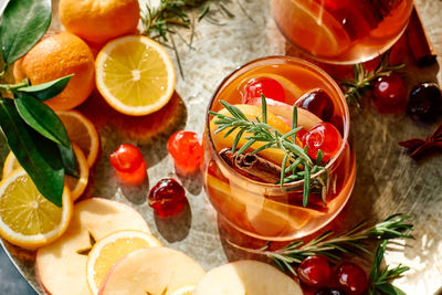 Mulled wine or christmas sangria with aromatic spices, apple, cherry and citrus fruits.