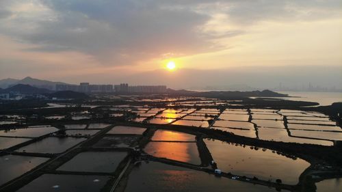 Aerial view of cityscape against sky during sunset