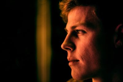 Close-up of thoughtful man in darkroom