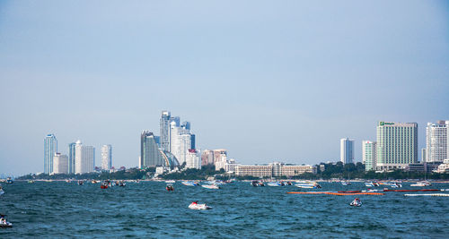View of skyscrapers in sea against clear sky