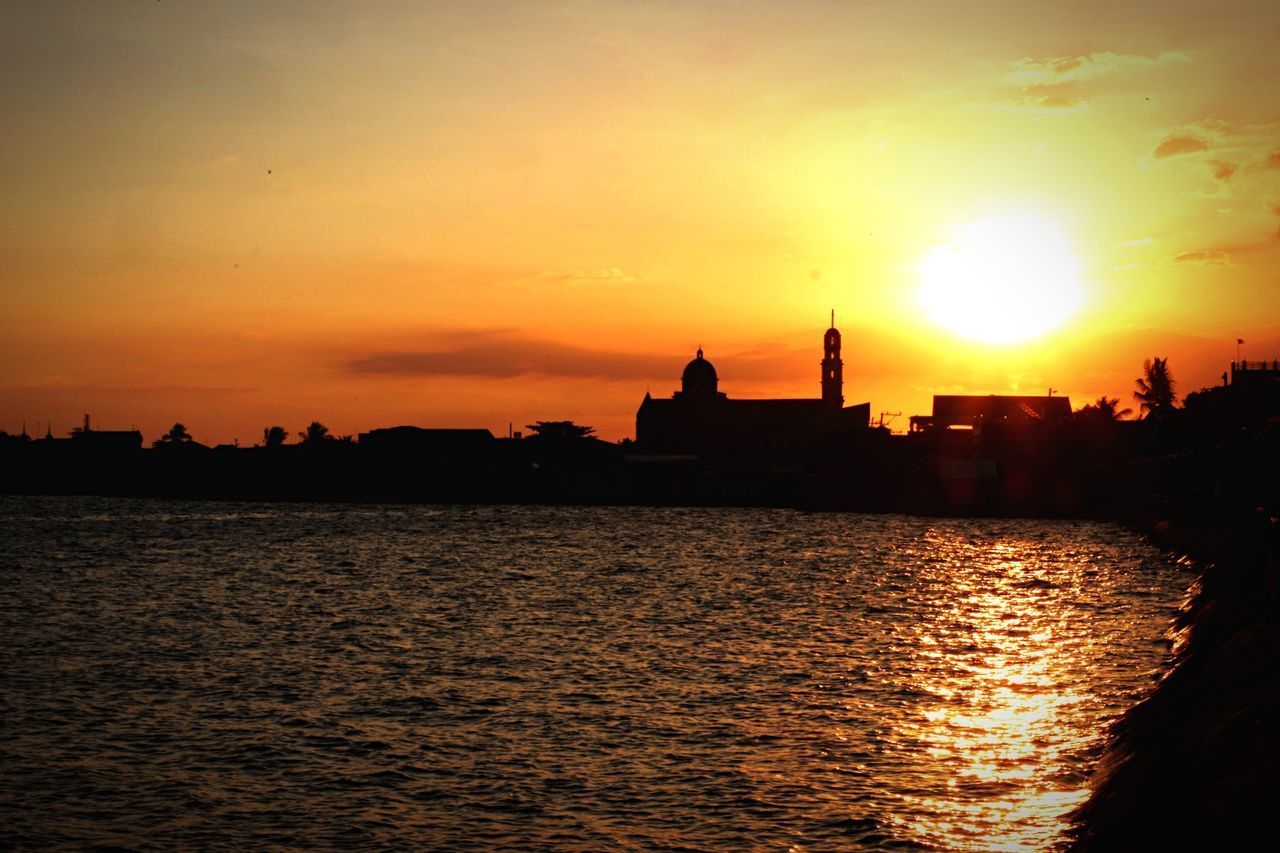 SILHOUETTE OF BUILDINGS AGAINST SKY DURING SUNSET