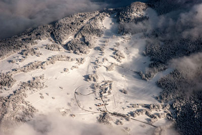 High angle view of snow covered mountain against sky