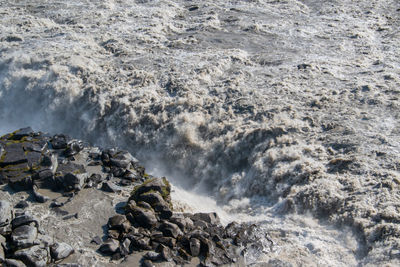 Waves splashing on rocks at shore