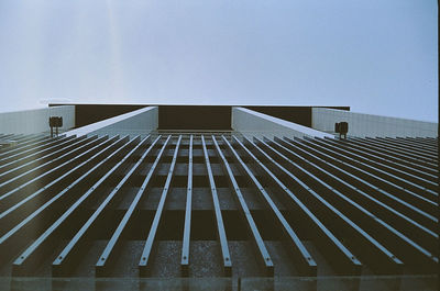 Low angle view of modern building against blue sky